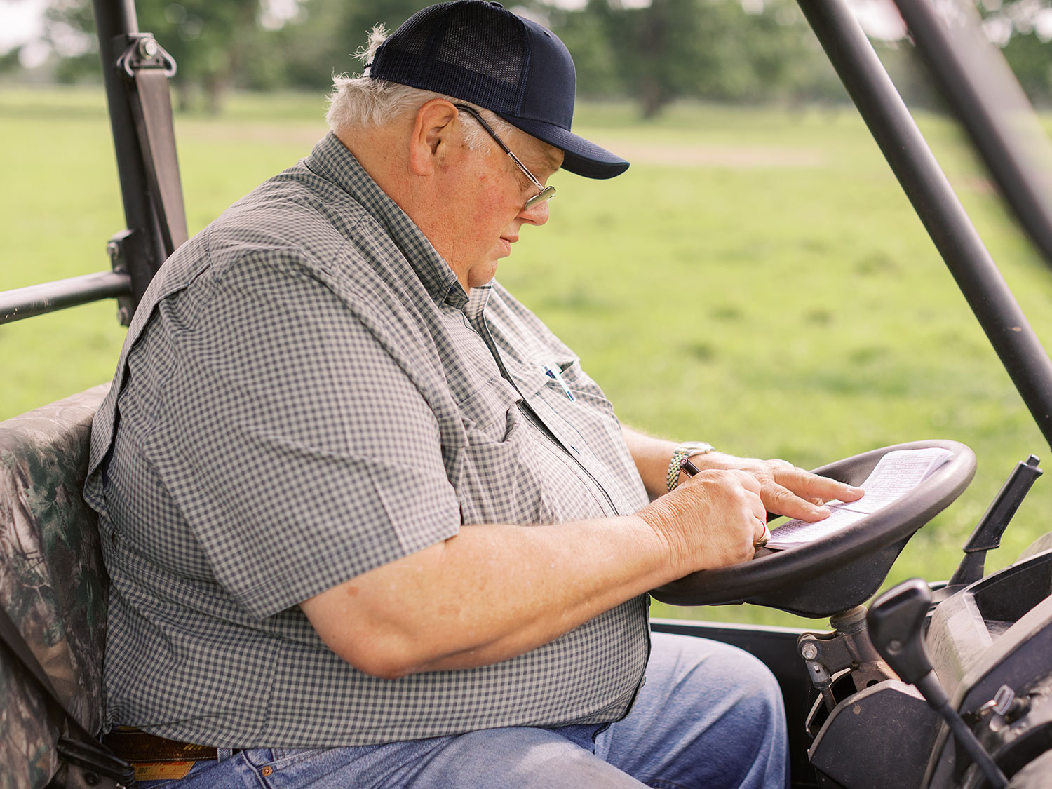 im Williams of V8 Ranch documenting birth records in the calving book—a commitment to honest, transparent cattle registration.